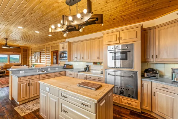 a spacious bedroom with a bed a couch and large windows