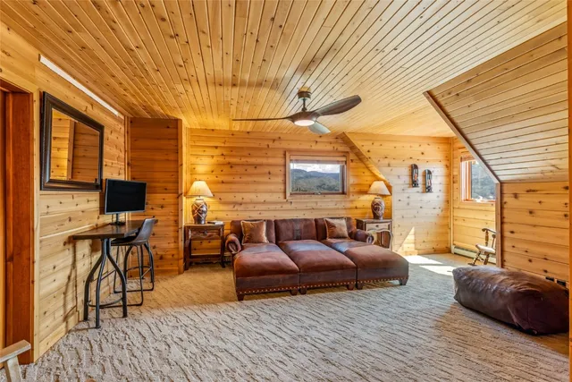 a bedroom with bed couch and window