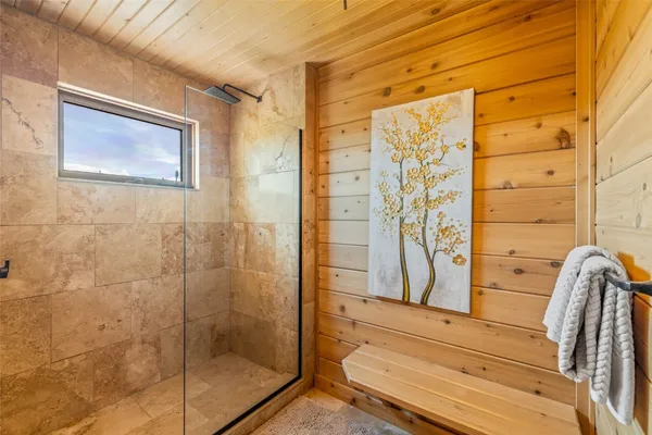 a bedroom with furniture and large windows