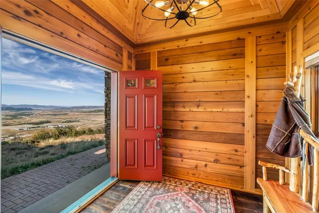 a view of a porch with wooden floor and furniture