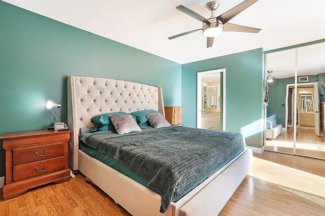 a bedroom with a large bed and a dresser