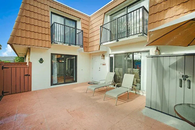 a view of a patio with a table and chairs