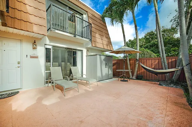 a view of a chair with an umbrella in patio