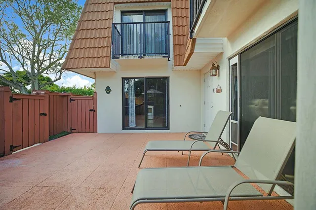 a balcony with table and chairs
