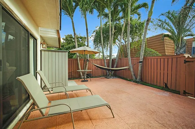 a view of a chairs and table in the balcony
