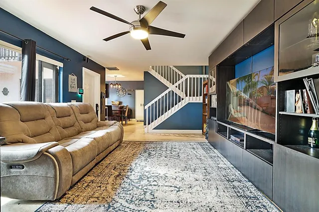 a living room with furniture or stairs and a chandelier