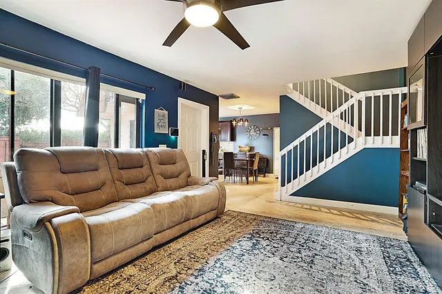 a living room with furniture and stairs