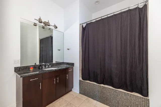 a bathroom with a double vanity sink and mirror
