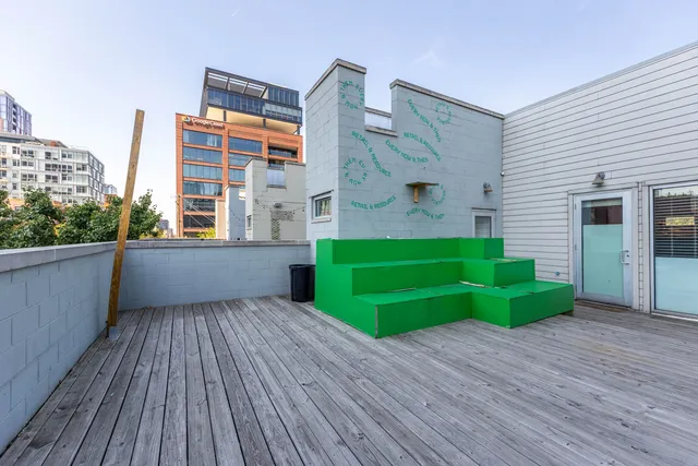 a view of a room with wooden floor and a window