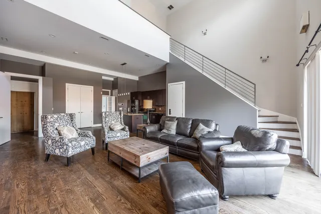 a living room with furniture and wooden floor
