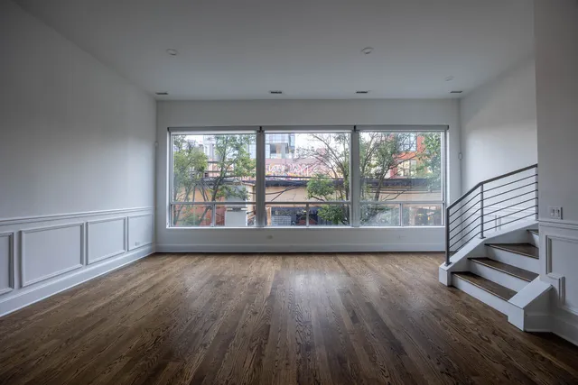 a view of wooden floor and windows in a room