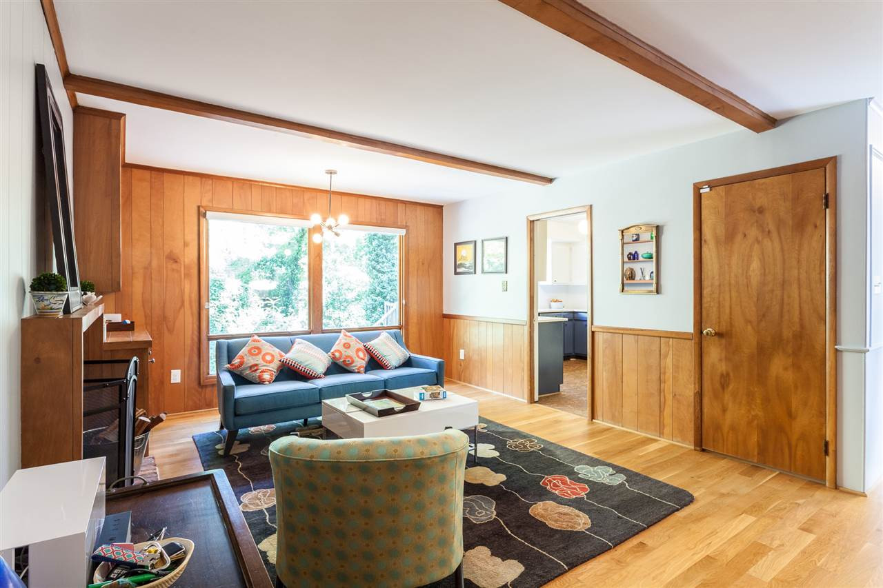 Cozy family room with wood-burning fire place and large windows overlooking the nice wooded backyard. Family Room