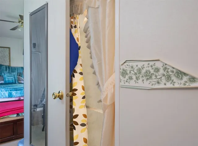 a bathroom with a granite countertop shower and a mirror