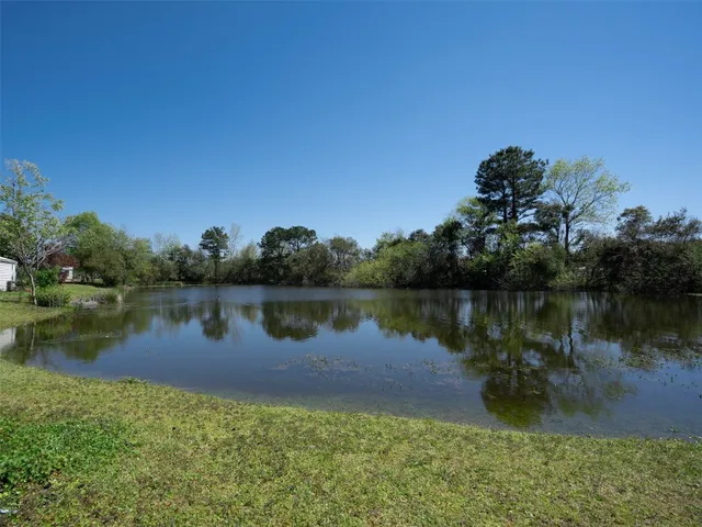 a lake with a building in the background