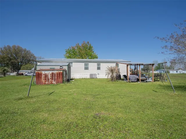 a view of house with backyard