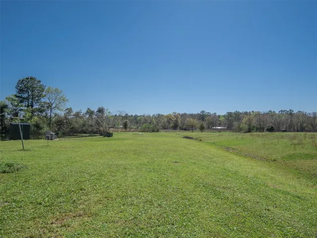 a big yard with lots of green space and deers