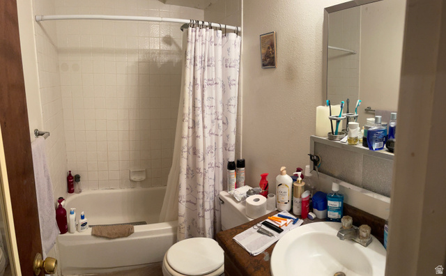 3977 Rivendell Road, Unit AB Taylorsville, UT 84129 - Photo 9 of 14 Full bathroom featuring a textured wall and shower / bath combo with shower curtain