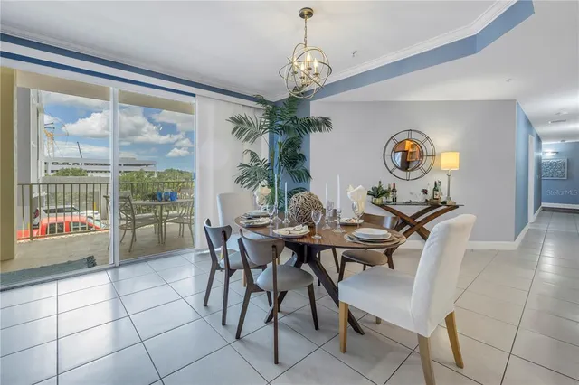 a view of a dining room with furniture and a chandelier