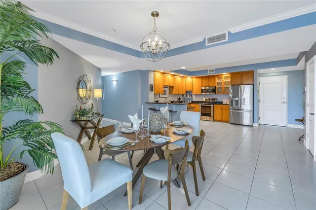 a dining room with furniture a chandelier and window