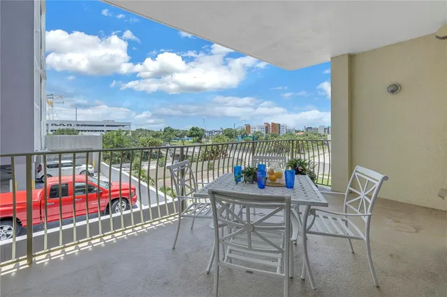 a view of a chairs and table in the balcony
