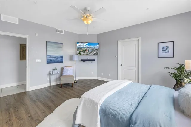 a bedroom with a bed and a chandelier