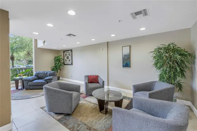a living room with furniture potted plant and a window