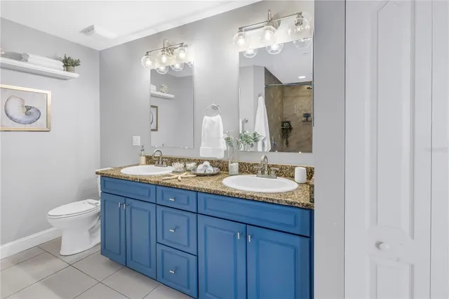 a bathroom with a double vanity sink and a mirror