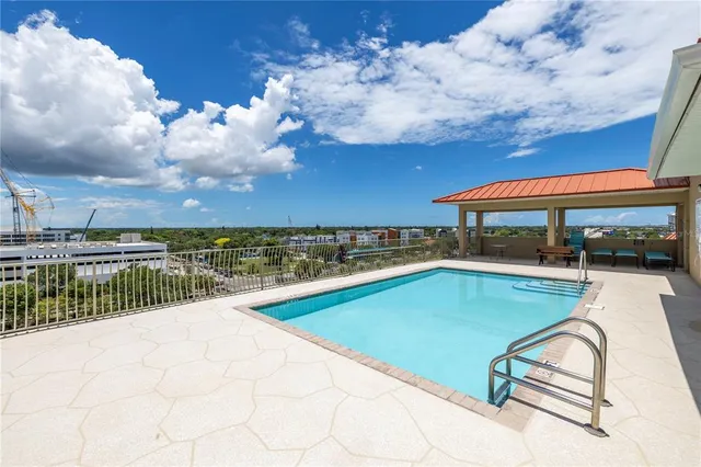 a terrace with a bench and city view