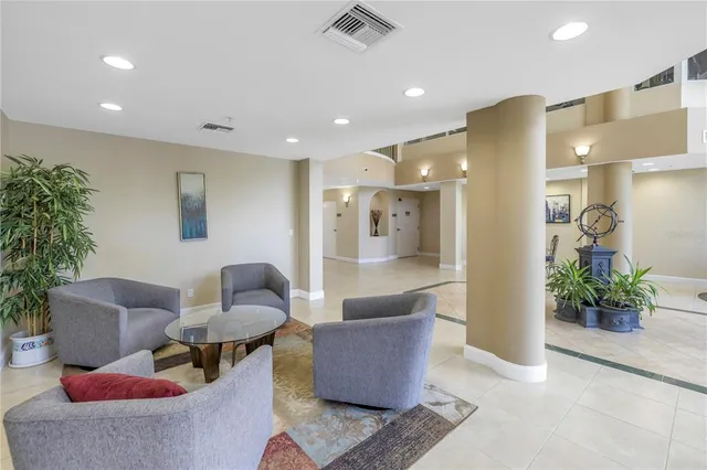 a living room with furniture and a potted plant