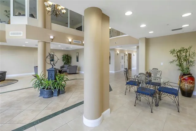 a lobby with furniture and a potted plant