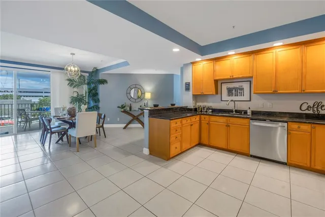 a kitchen with granite countertop a sink and a stove