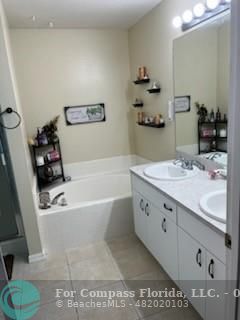 a bathroom with a bathtub sink and a mirror