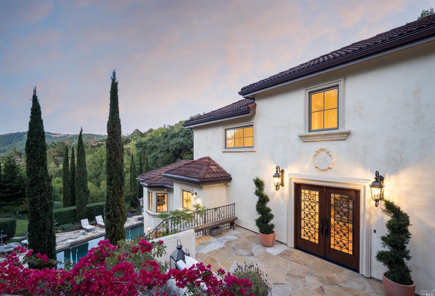 a front view of a house with a garden