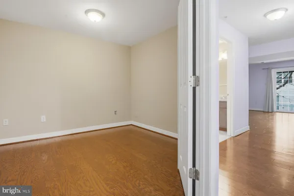 a view of a room with wooden floor