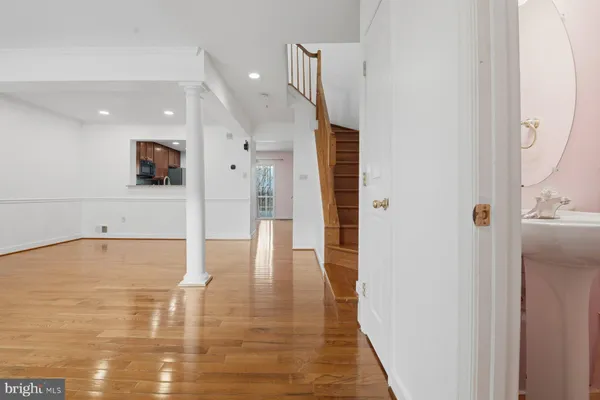 a view of a hallway with wooden floor and staircase