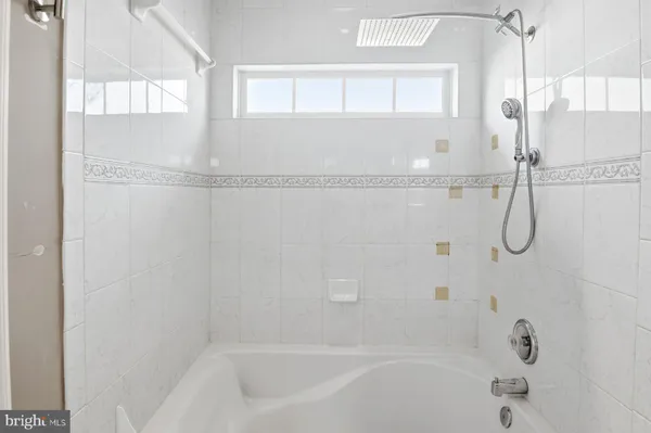 a bathroom with a bath tub with a shower