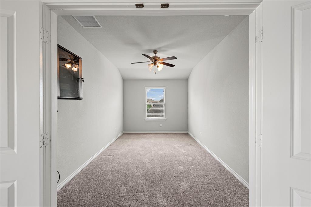 437 Prairie Run Aledo, TX 76008 - Photo 22 of 33 Spacious room featuring neutral carpeting, a ceiling fan, a window with blinds, and white trim