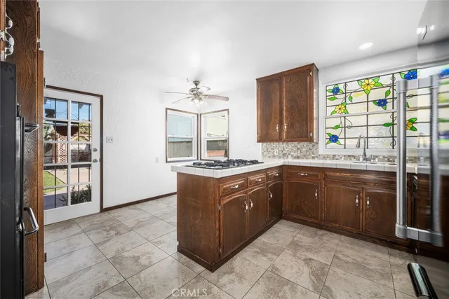 a kitchen with stainless steel appliances granite countertop a sink and cabinets