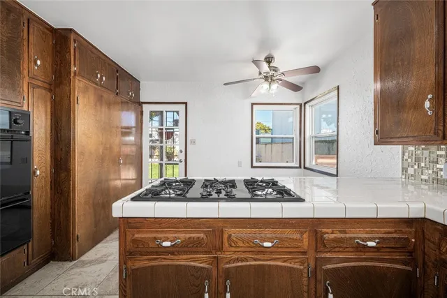 a kitchen with a stove a sink and a refrigerator