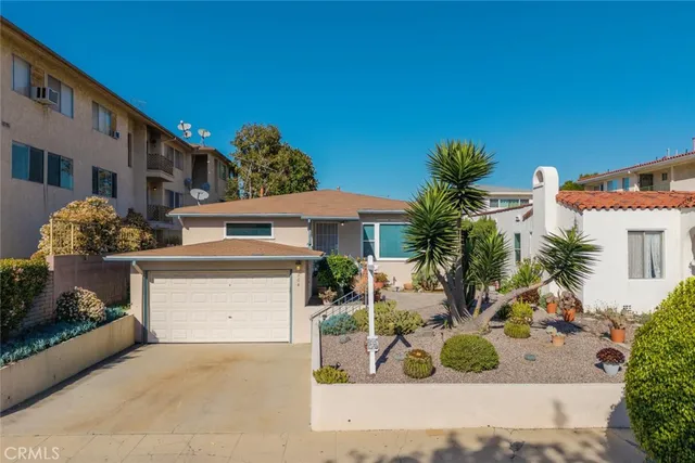 a front view of a house with garden