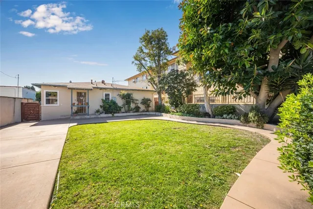 a view of house with a backyard