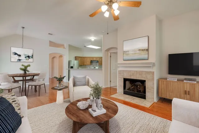 a living room with furniture a fireplace and a flat screen tv