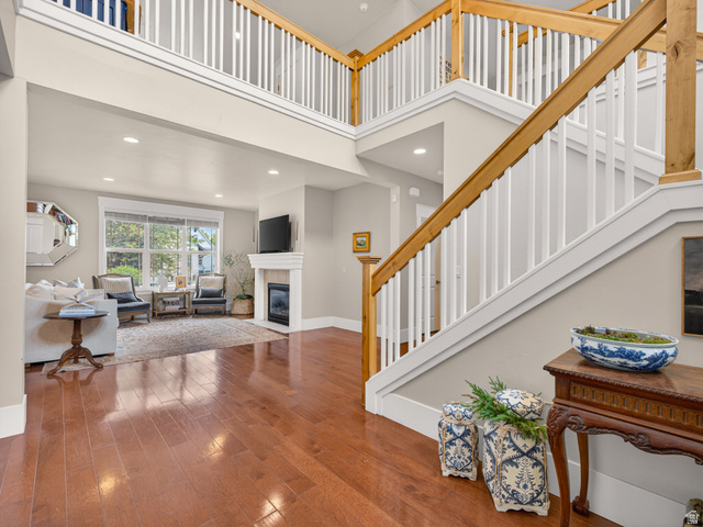 557 Craftsman Way Midway, UT 84049 - Photo 8 of 59 Two-story interior featuring a grand staircase with wood railings and white balusters