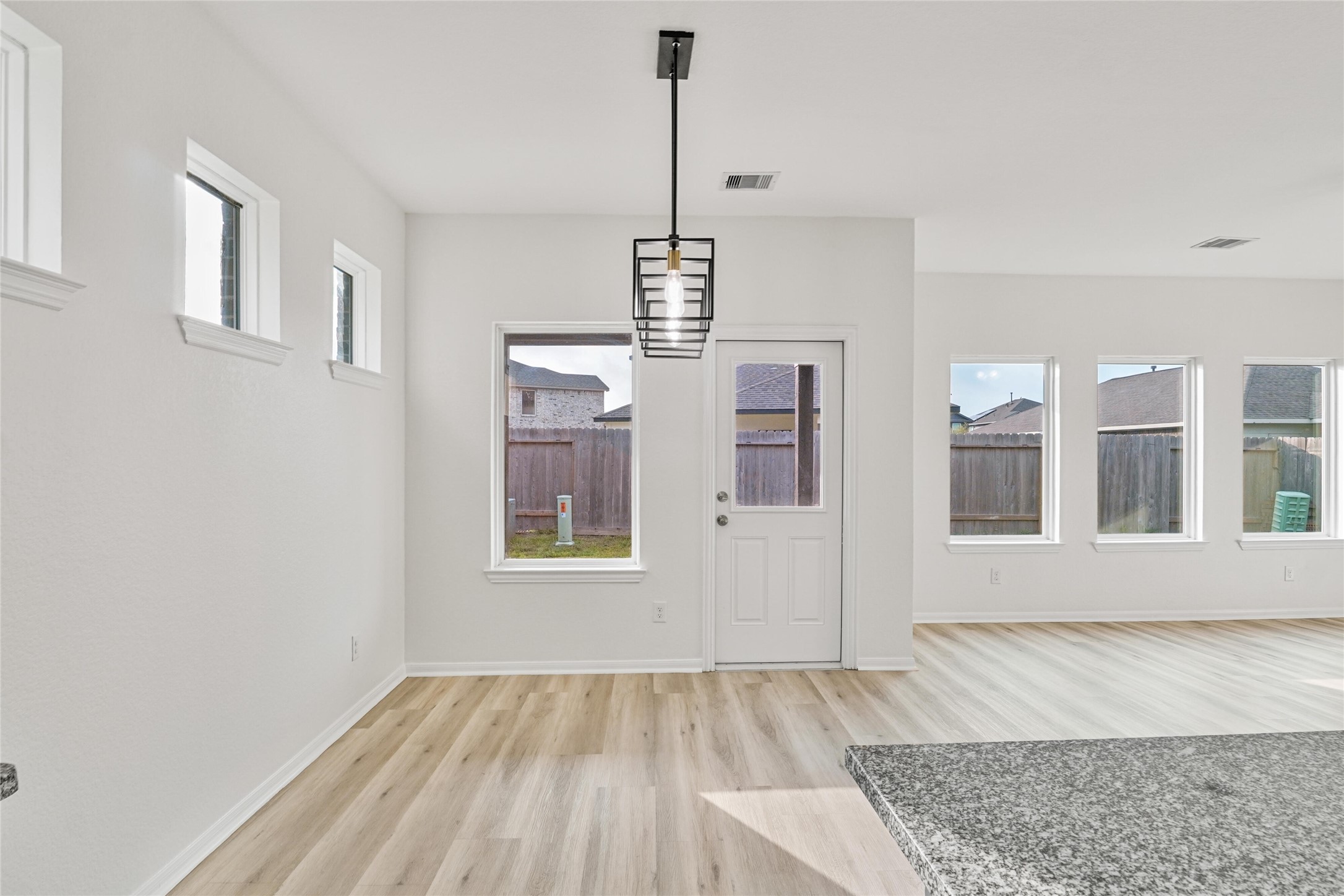 10511 Kings River Drive Rosharon, TX 77583 - Photo 10 of 25 a view of an empty room with wooden floor and a window