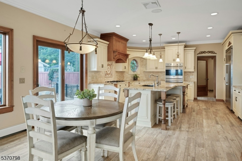 656 Lakeside Avenue Hopatcong, NJ 07821 - Photo 11 of 36 a view of a dining room and livingroom with furniture wooden floor a chandelier