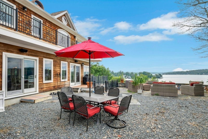 656 Lakeside Avenue Hopatcong, NJ 07821 - Photo 15 of 36 a view of a house with backyard porch and furniture
