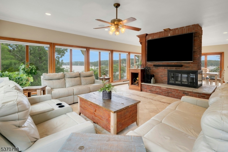 656 Lakeside Avenue Hopatcong, NJ 07821 - Photo 20 of 36 a living room with fireplace furniture and a flat screen tv