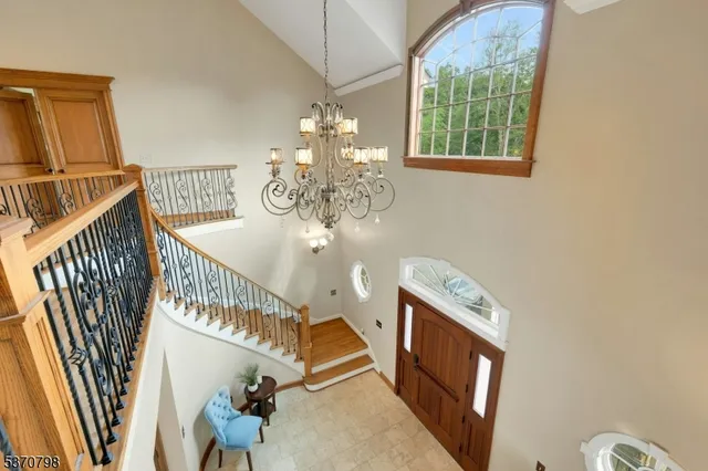 a spacious bedroom with a bed and a chandelier