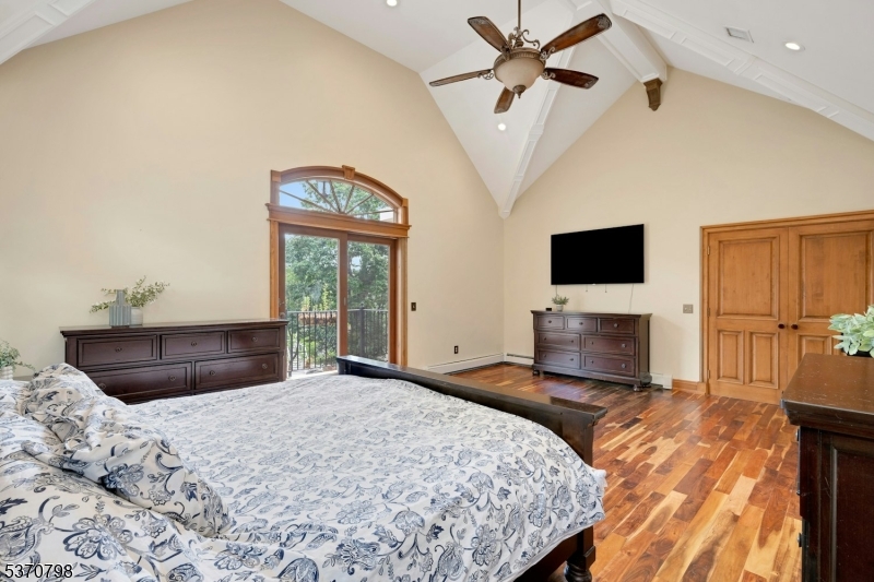 656 Lakeside Avenue Hopatcong, NJ 07821 - Photo 28 of 36 a bedroom with a bed and a flat screen tv