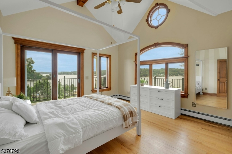 656 Lakeside Avenue Hopatcong, NJ 07821 - Photo 29 of 36 a bed sitting in a bedroom next to a large window